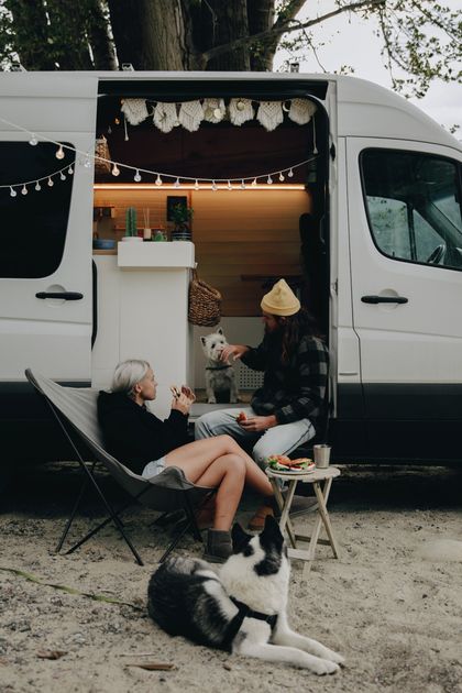 small RV parked in town with couple