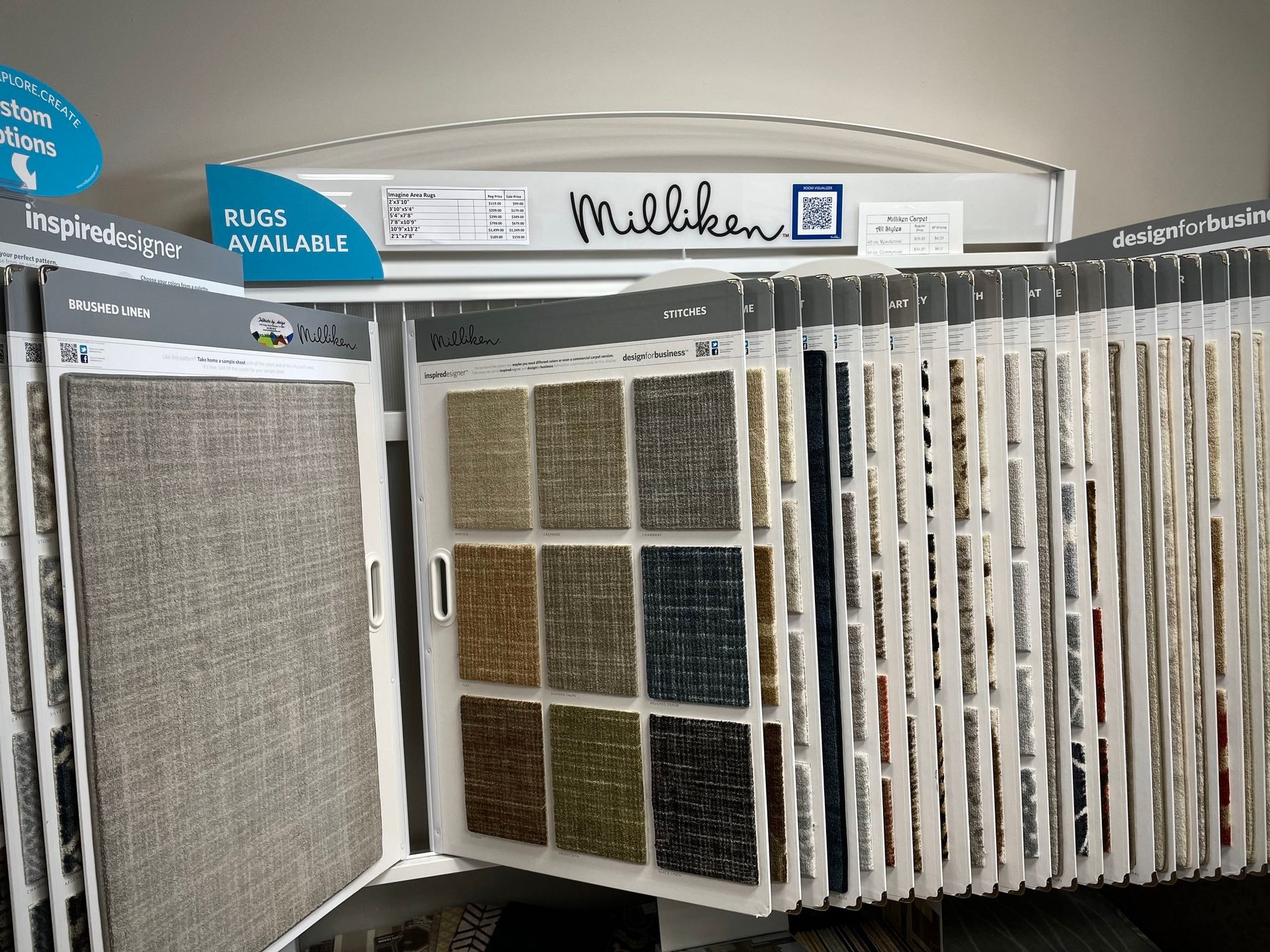 Store display of wall-to-wall carpet and rug samples in a showroom