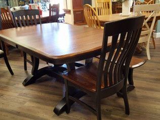 Wooden dining table with matching chairs in a furniture showroom