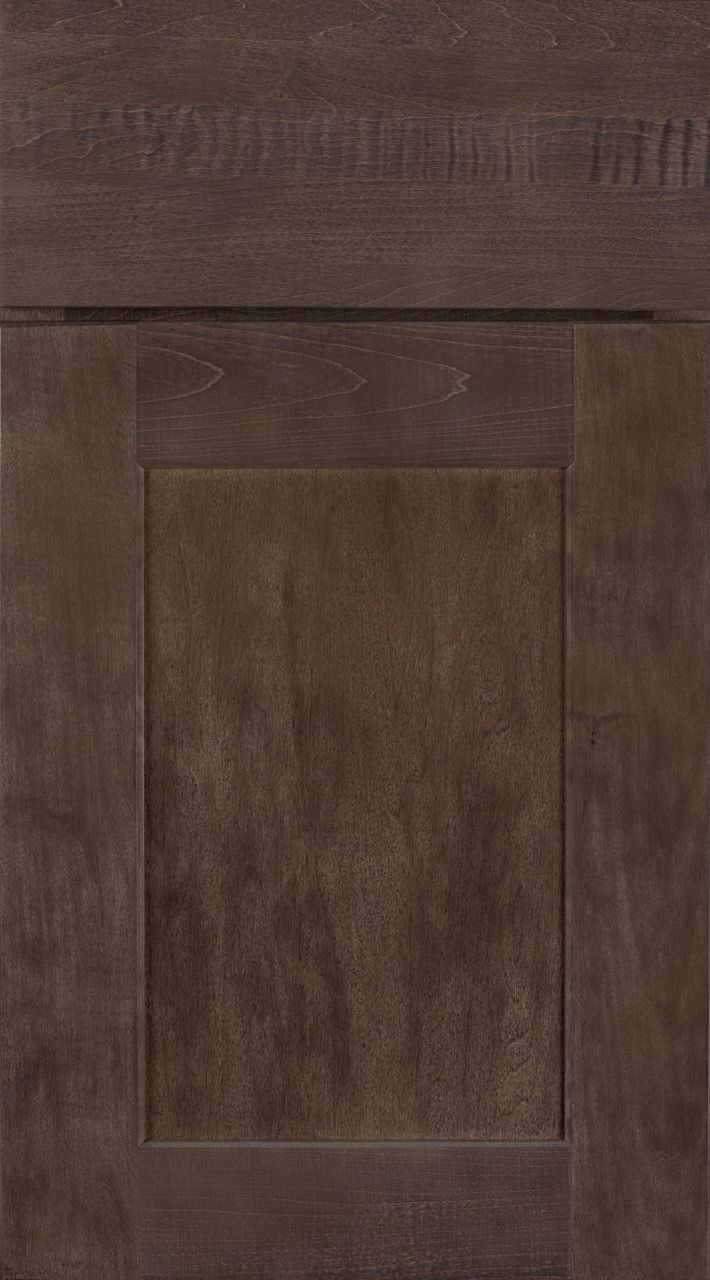 Close-up of a dark brown wooden cabinet door with recessed paneling and visible grain.