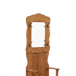 Wooden standing mirror with carved frame above a chair