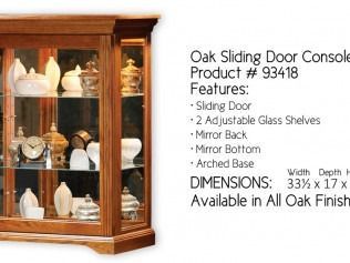 Oak sliding door console with glass shelves, mirror back and bottom, arched base, in oak finish.