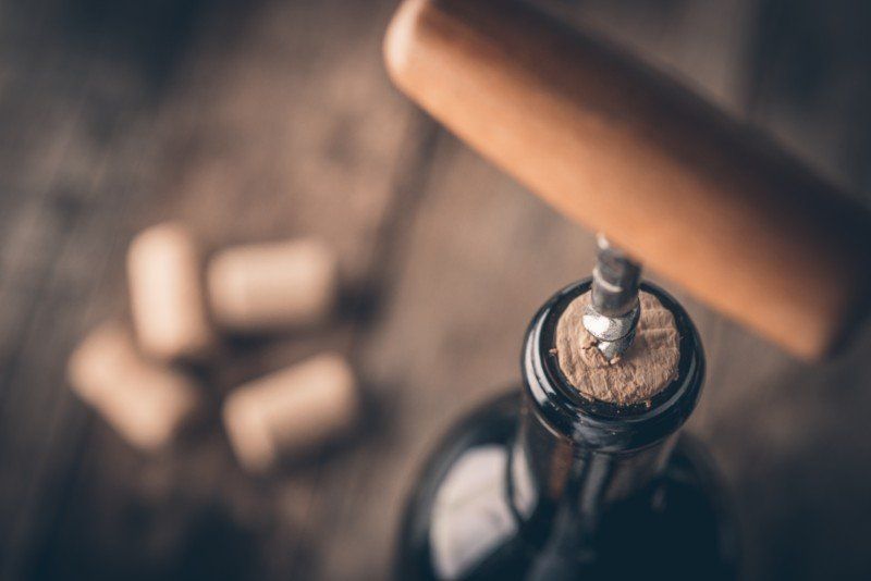 bottle opener being used to open the bottle