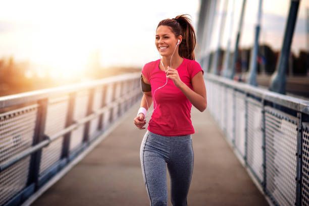 Young Woman Jogging on Bridge — Dunedin, FL — Bloom IV Hydration & Wellness