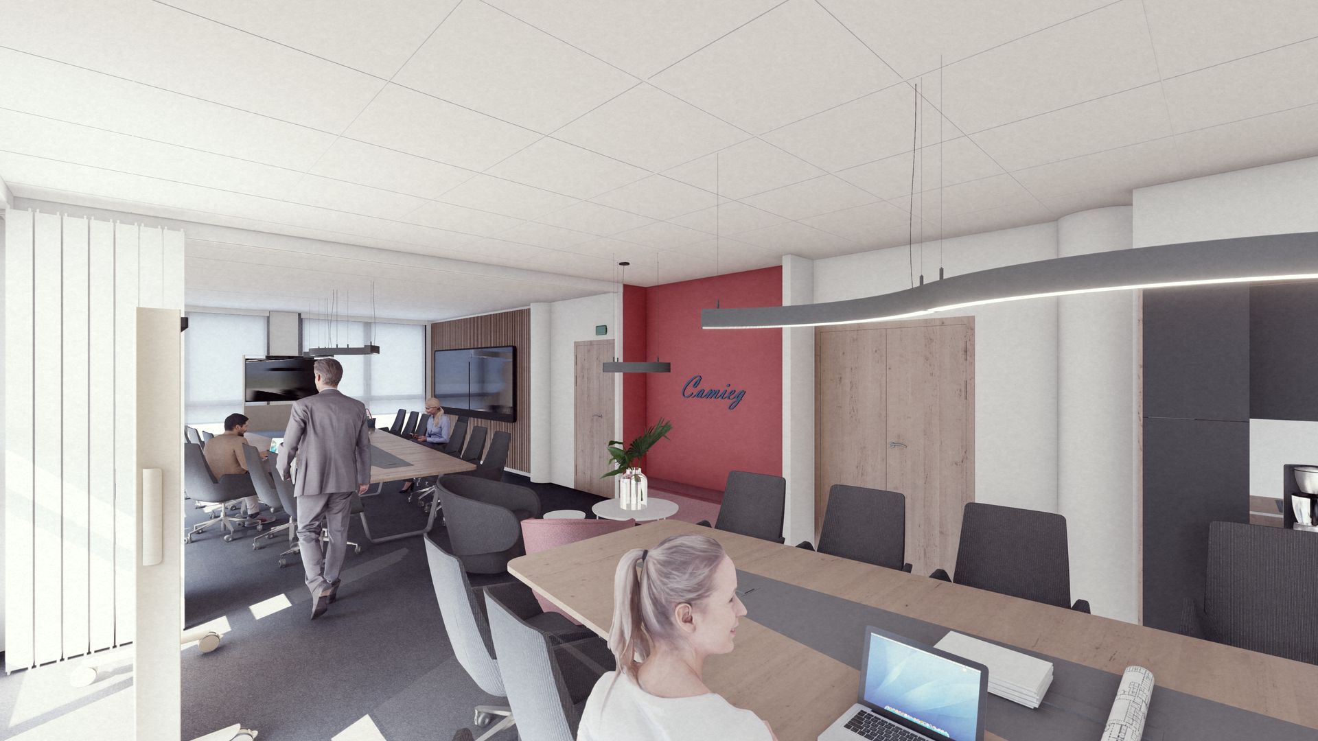 Une cuisine commerciale stérile et vide, avec un sol carrelé gris, des postes de travail en acier inoxydable et des murs blancs.