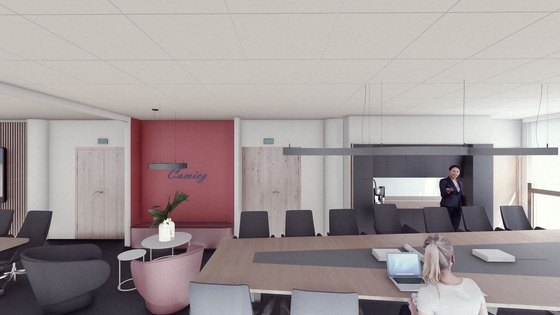 Une salle de classe lumineuse avec plusieurs planches à repasser alignées près de grandes fenêtres et une grande table sur la droite.