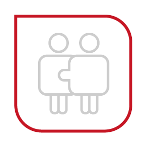 Two people are holding a piece of a puzzle together.