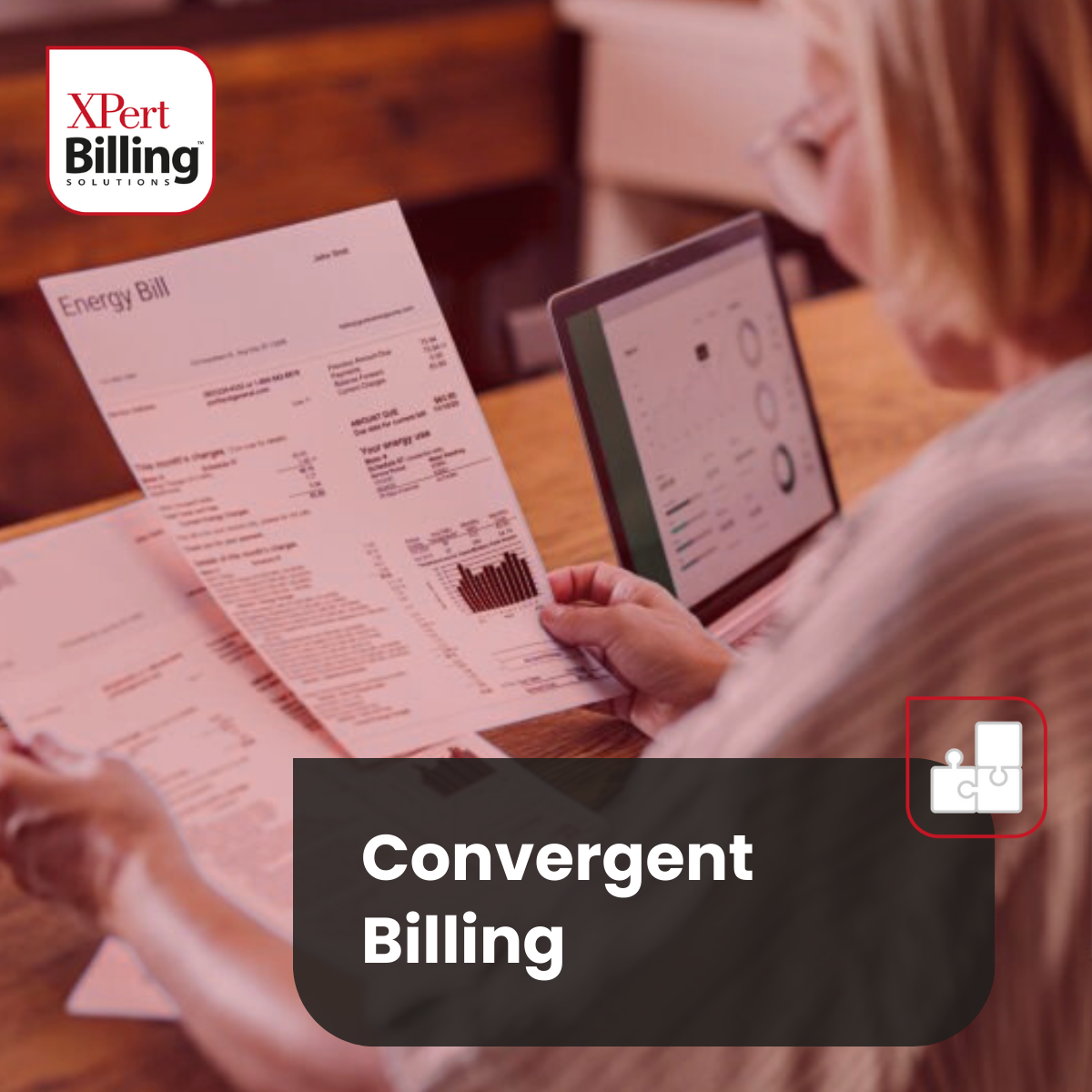 A woman is sitting at a table reading a bill and using a laptop.