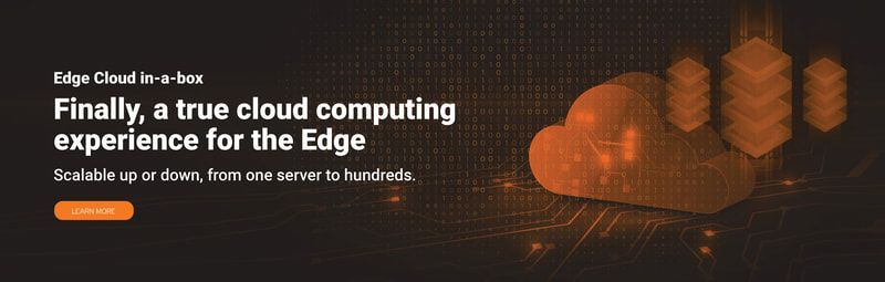 A woman is sitting at a table reading a bill and using a laptop.