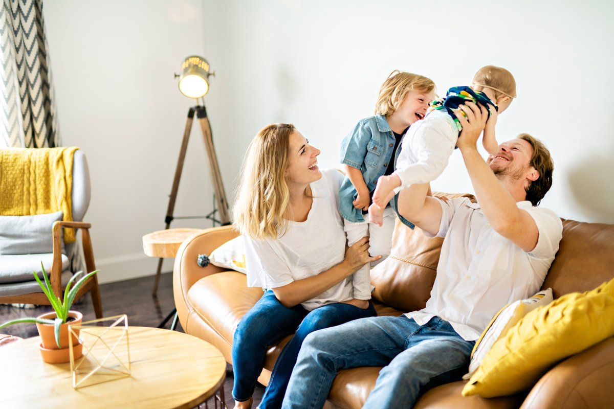 Family Having Fun on Sofa — Nicholasville, KY — Stewart Air Conditioning & Heating