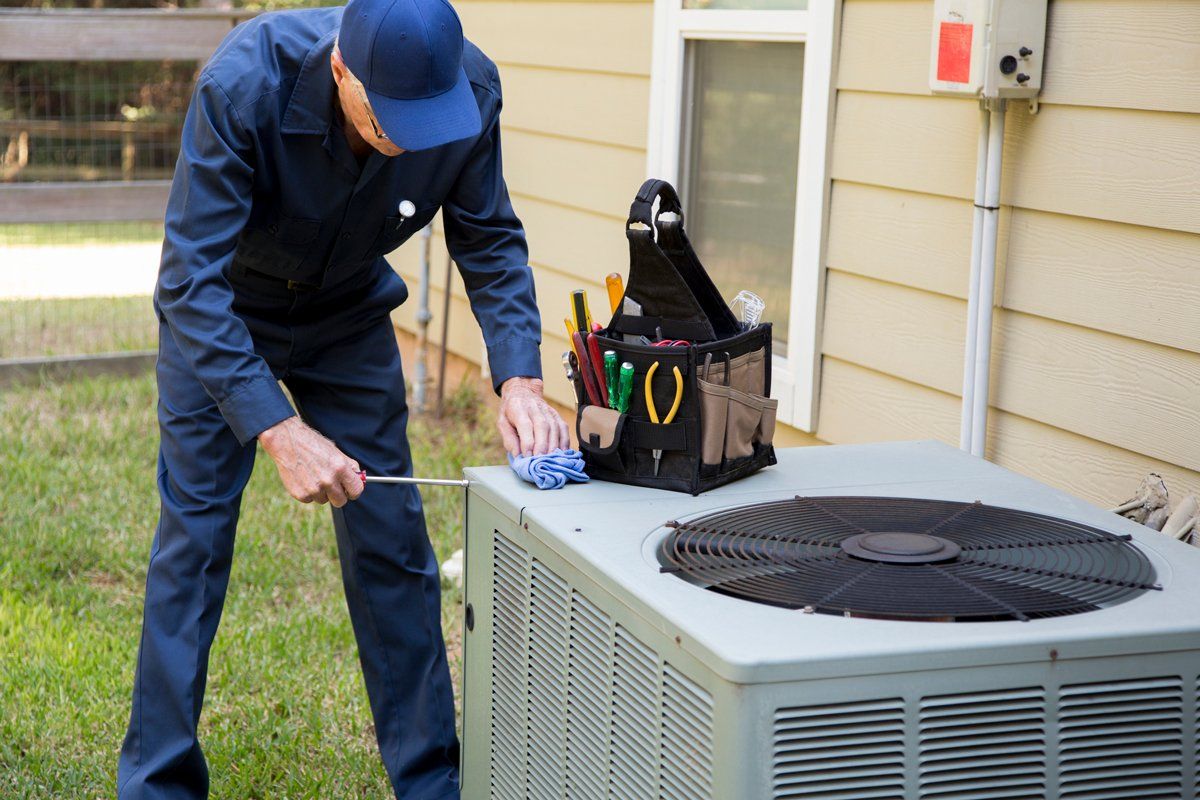 Technician Repairing the Air Conditioner — Nicholasville, KY — Stewart Air Conditioning & Heating