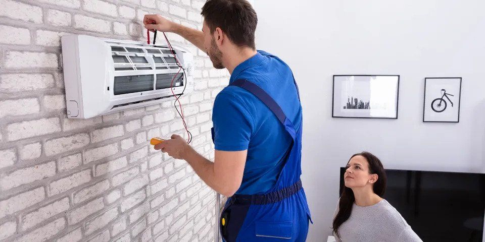 Man Repairing Air Conditioner — Nicholasville, KY — Stewart Air Conditioning & Heating
