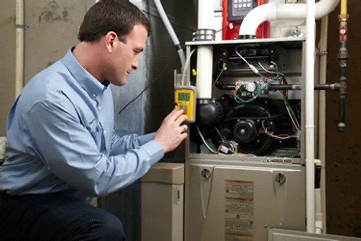 Technician Repairing Furnace — Nicholasville, KY — Stewart Air Conditioning & Heating