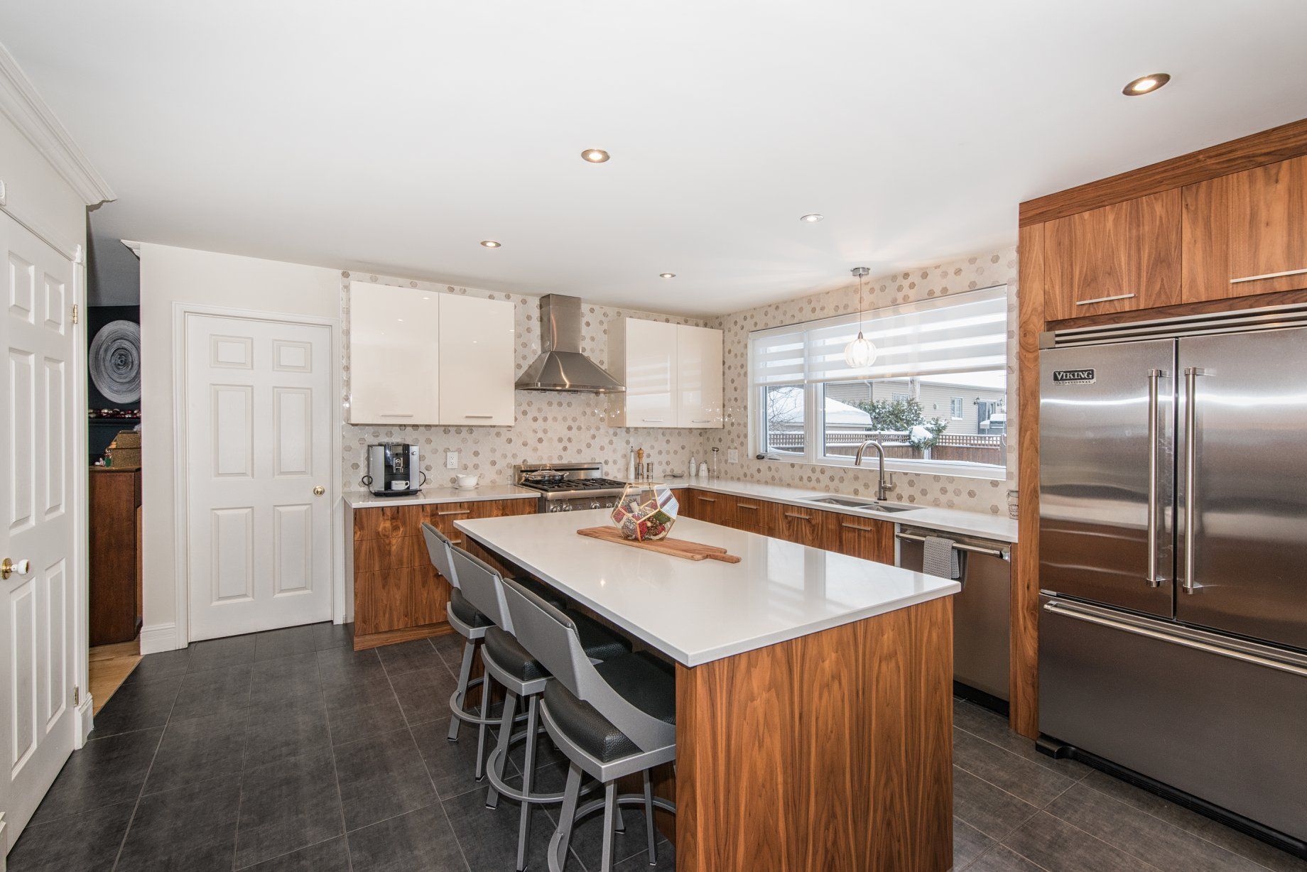 Une cuisine avec électroménagers en acier inoxydable et un grand îlot.