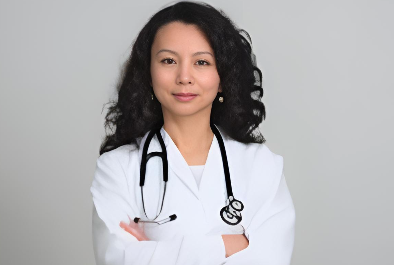 A doctor is holding a bottle of pills and a model of a kidney.