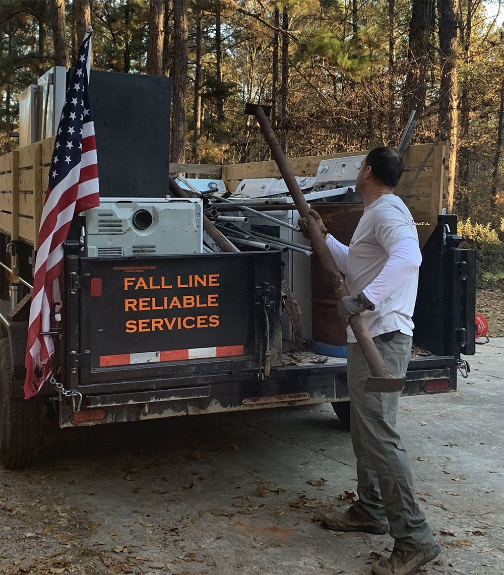 Man Removing Junk From Fall Line Removal
