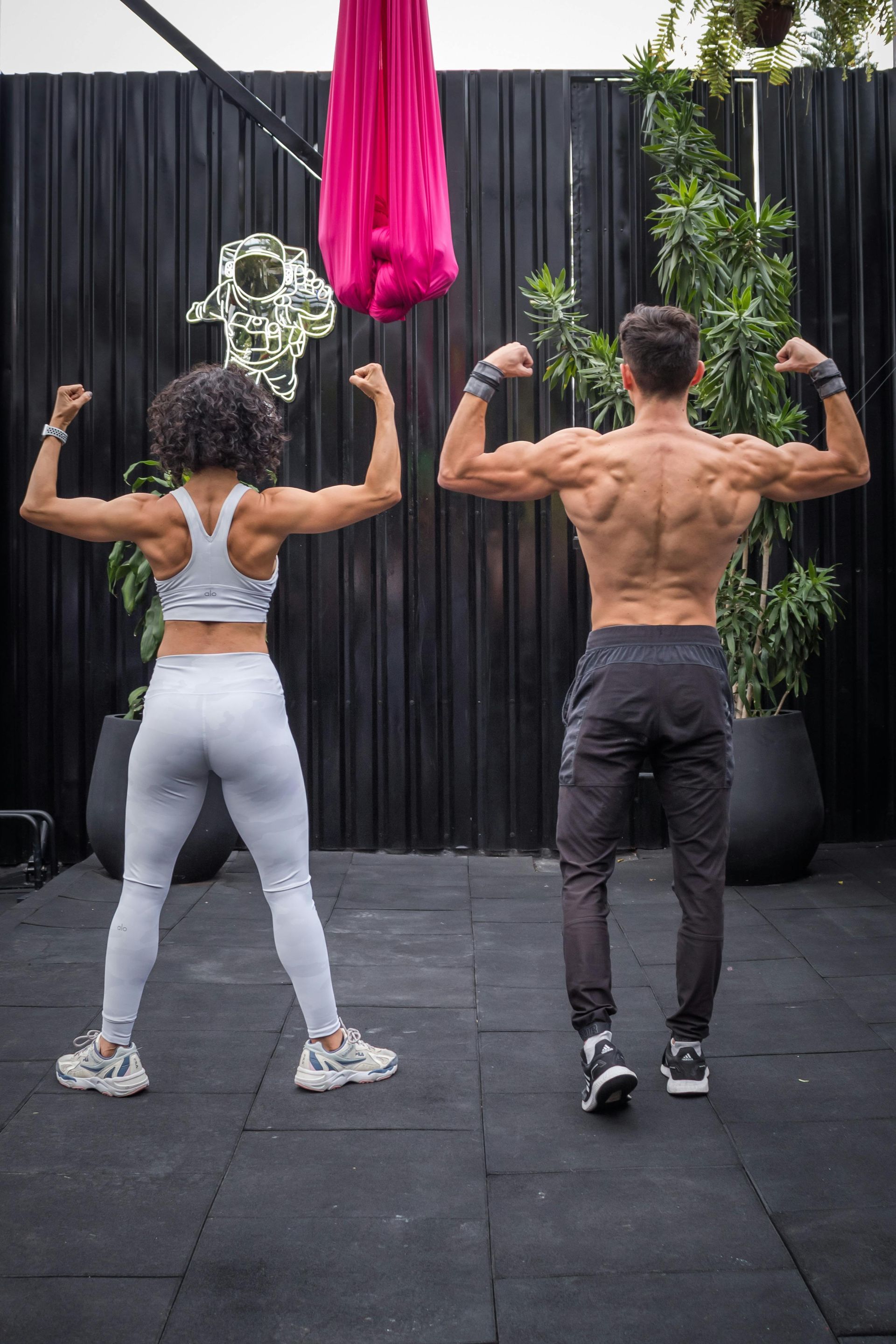 woman and man showing muscles after exercising 