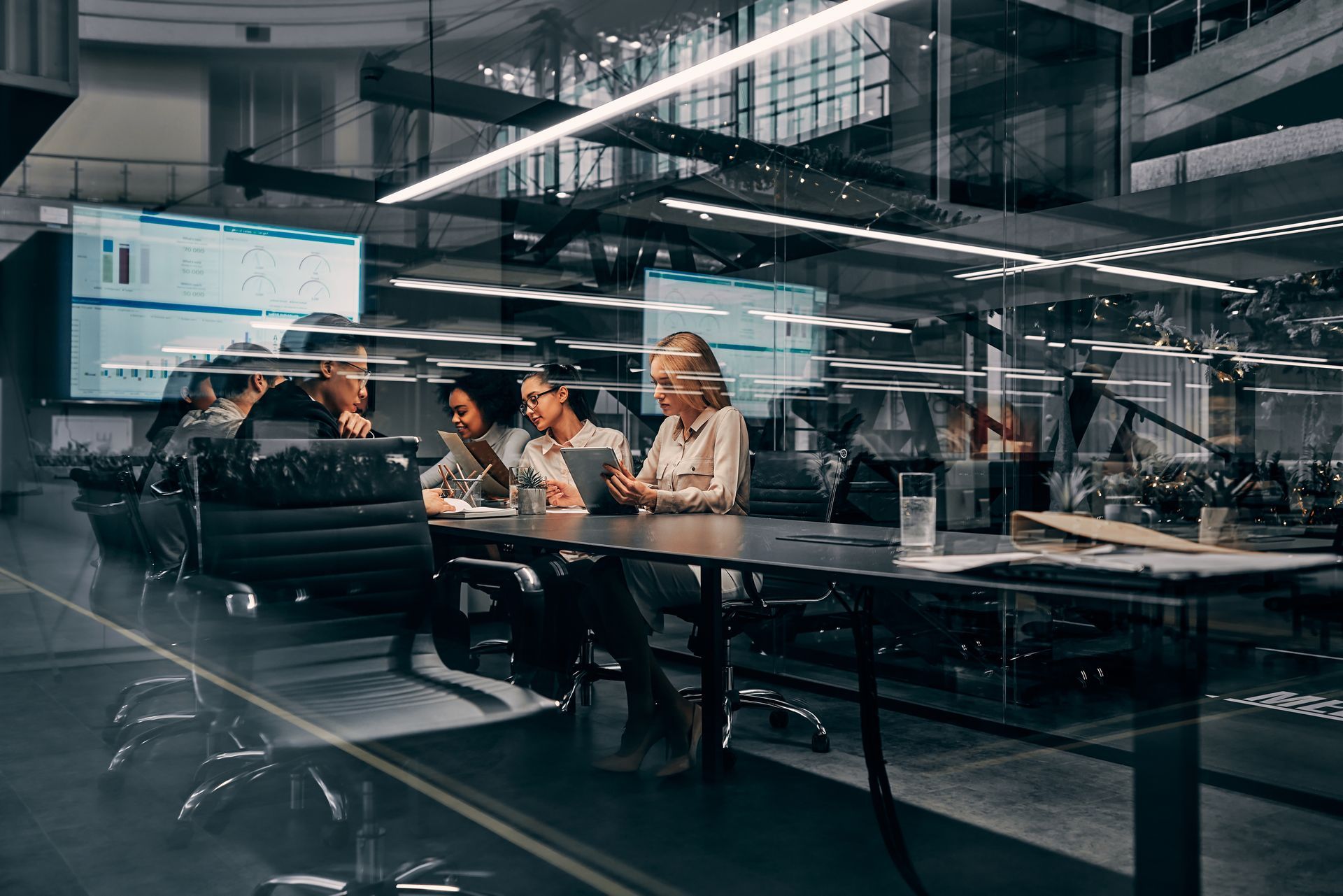A group of people are sitting around a table in a conference room.