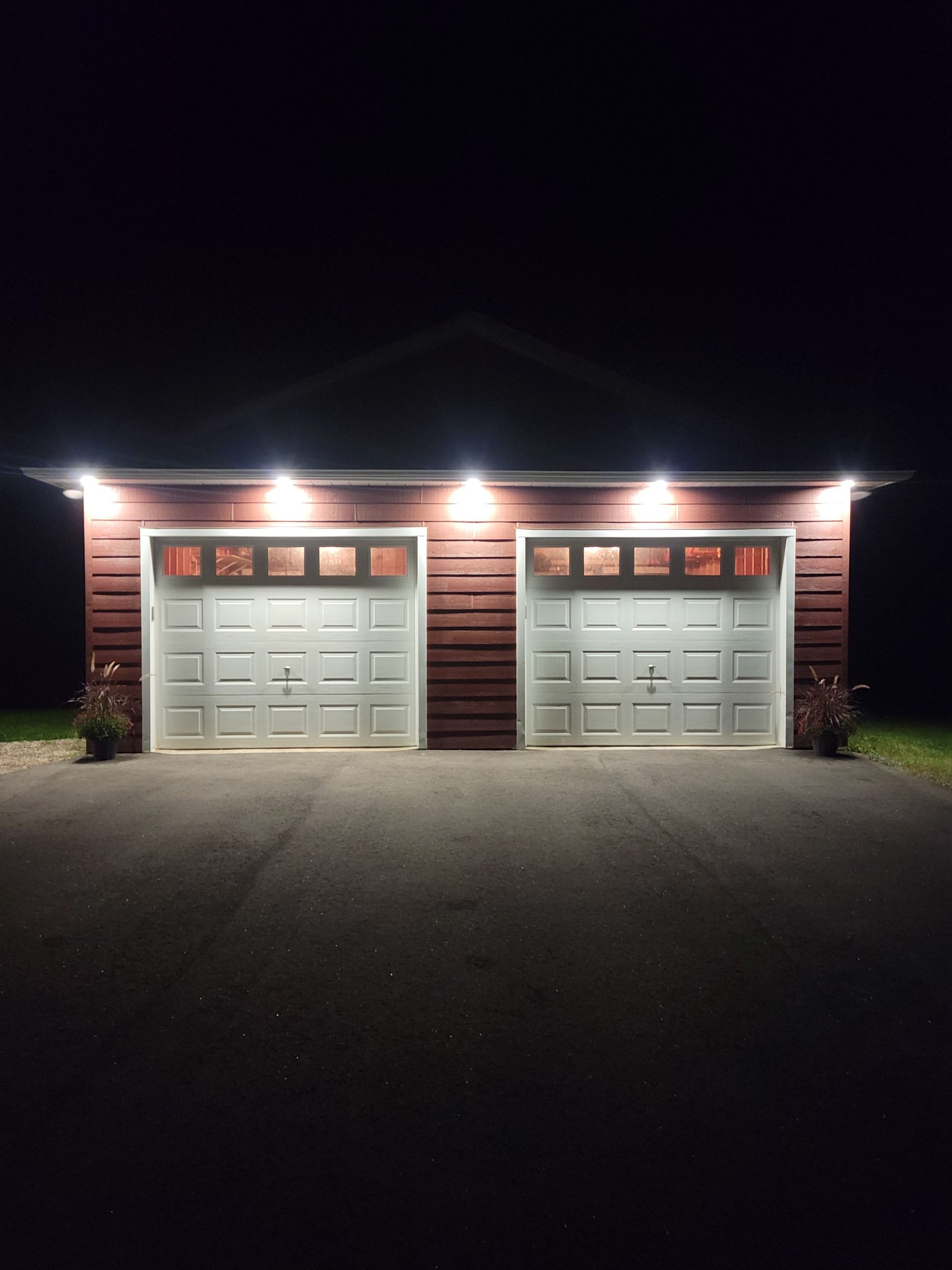 A couple of garage doors that are lit up at night
