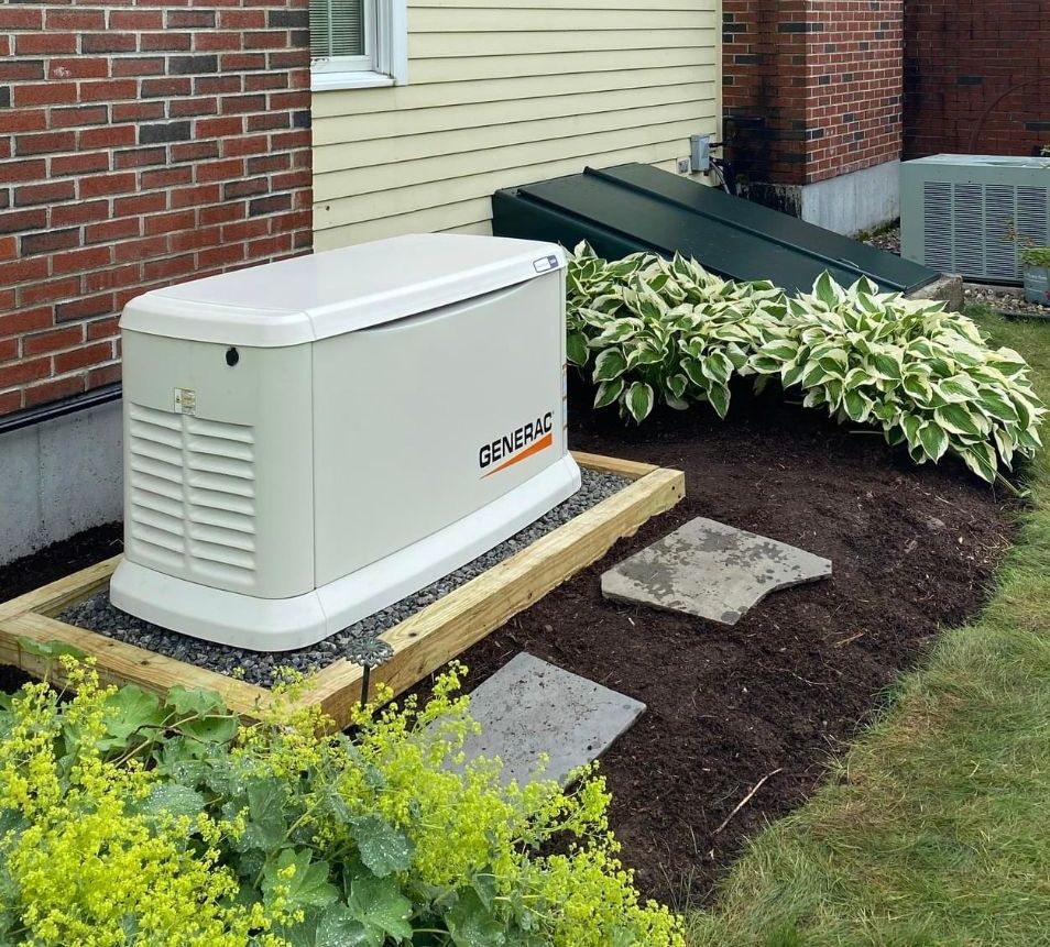 A generator is sitting on the side of a brick house