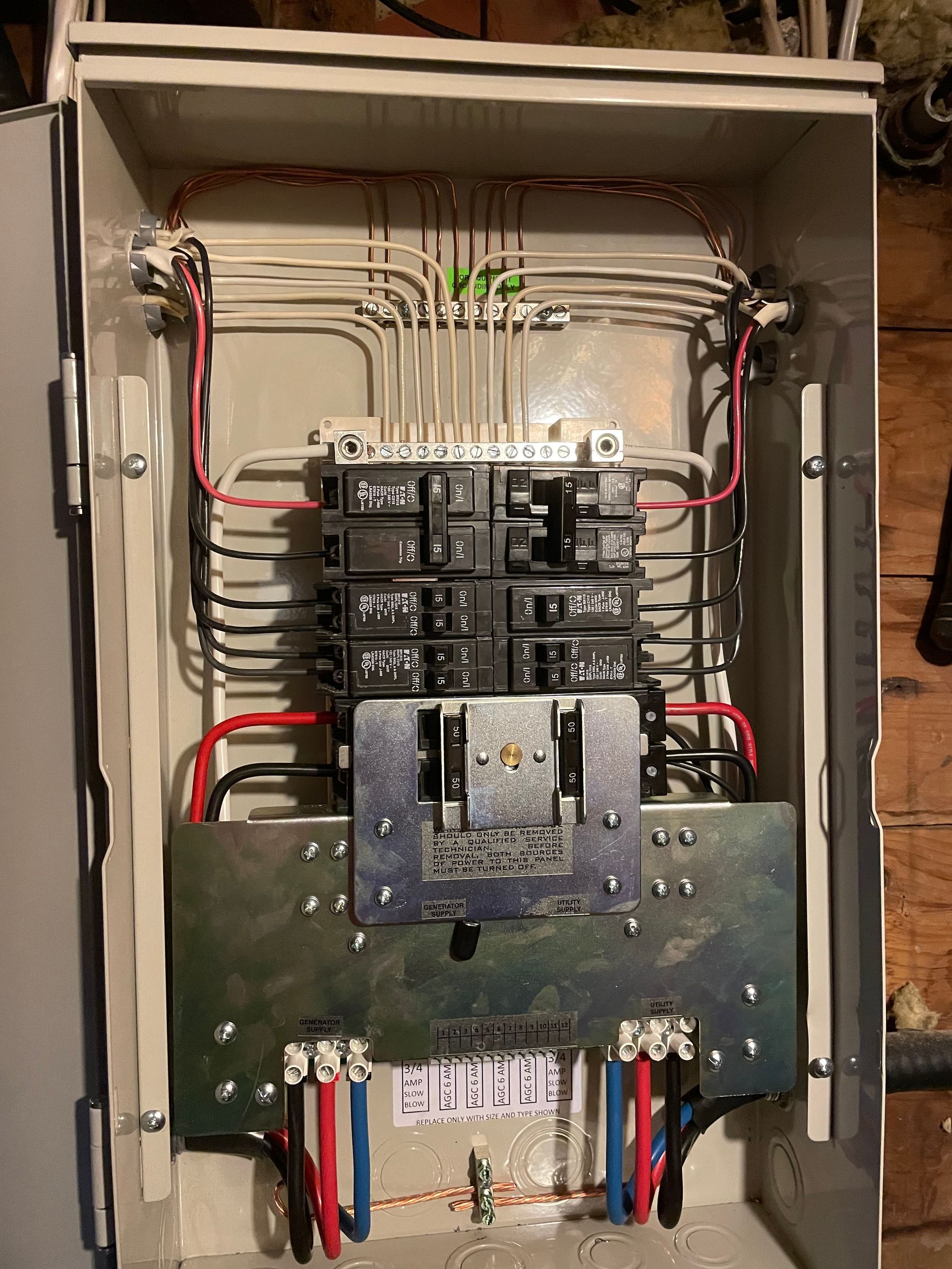 The inside of a electrical box with a lot of wires coming out of it.
