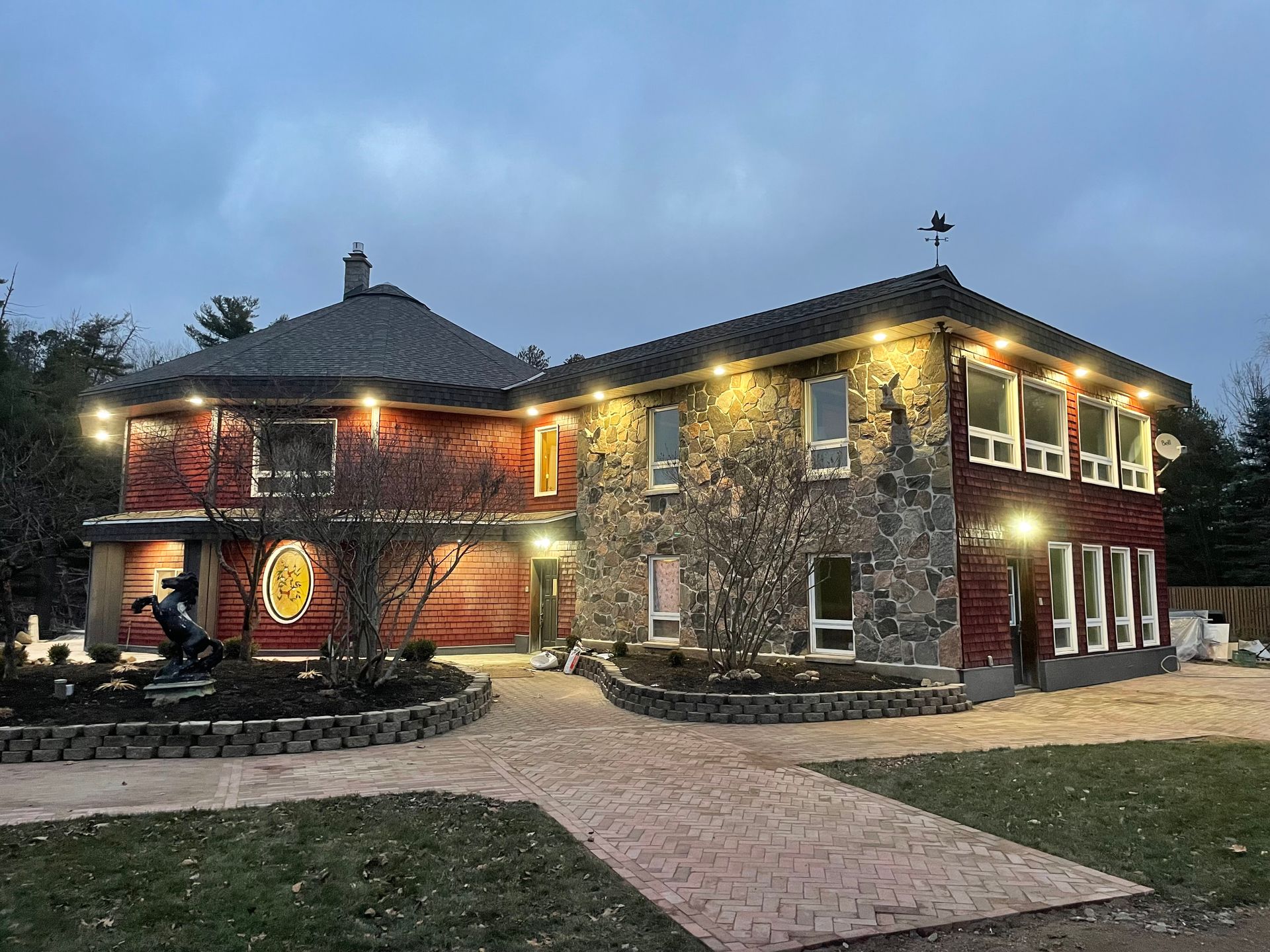 A large house with a lot of windows is lit up at night.
