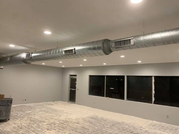 a large room with a ceiling fan and a lot of windows .