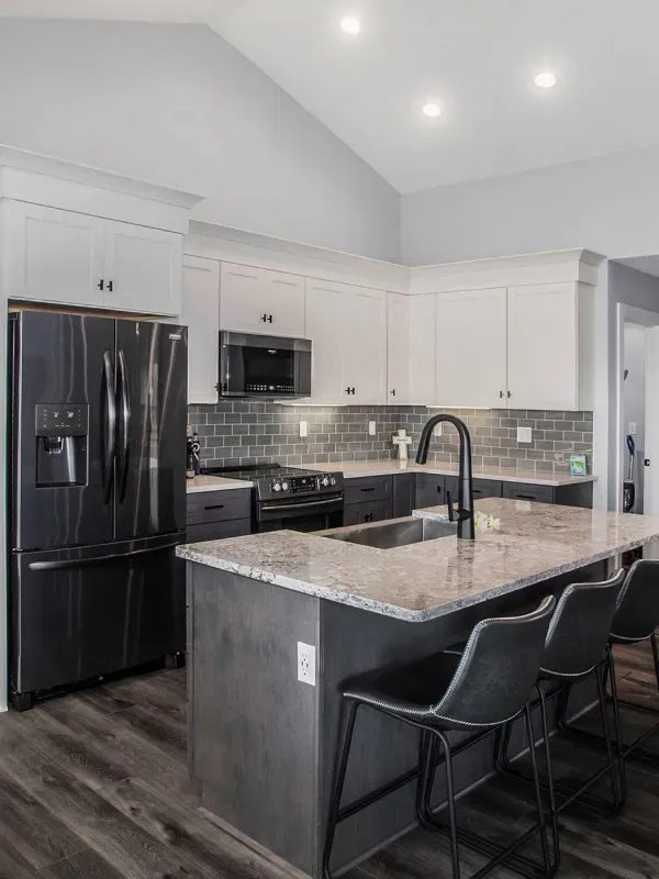 A kitchen with stainless steel appliances and granite counter tops.