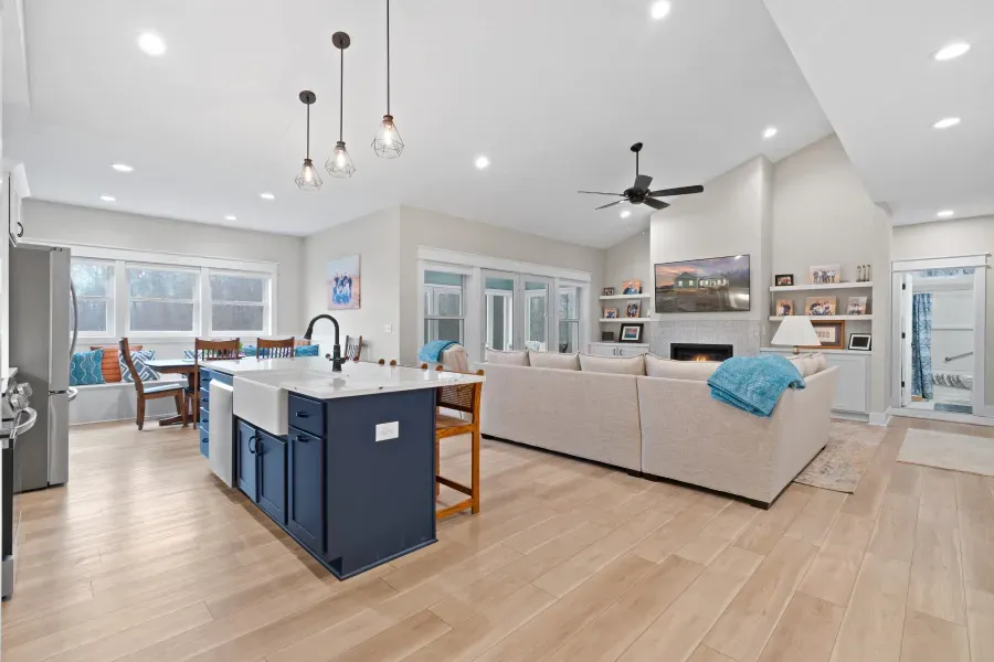 A kitchen , living room , dining room and a fireplace in a house.