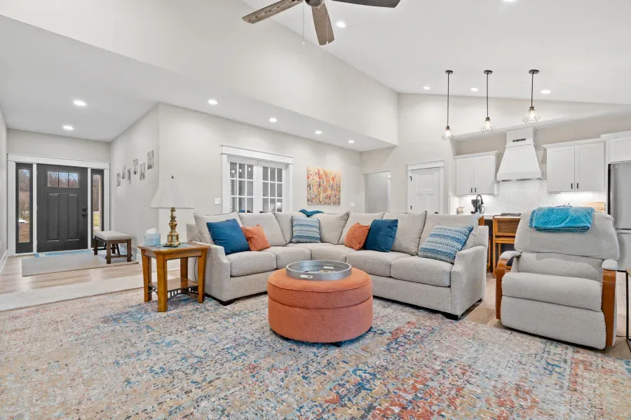 A living room filled with furniture and a ceiling fan.