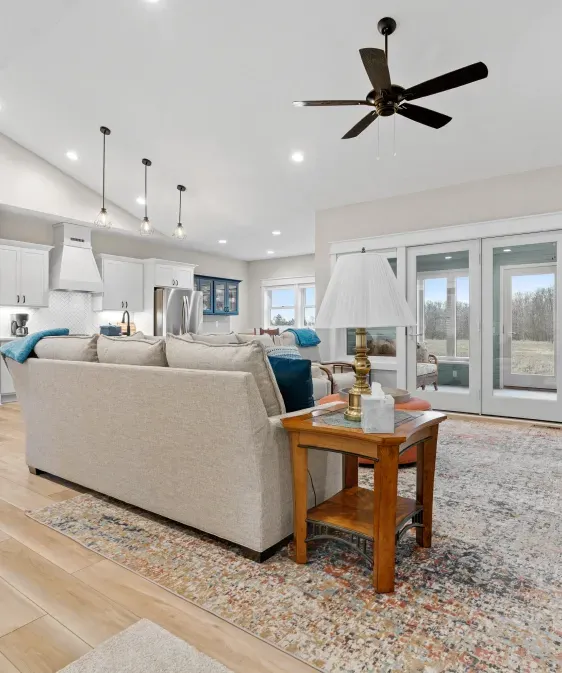 A living room with a couch and a ceiling fan