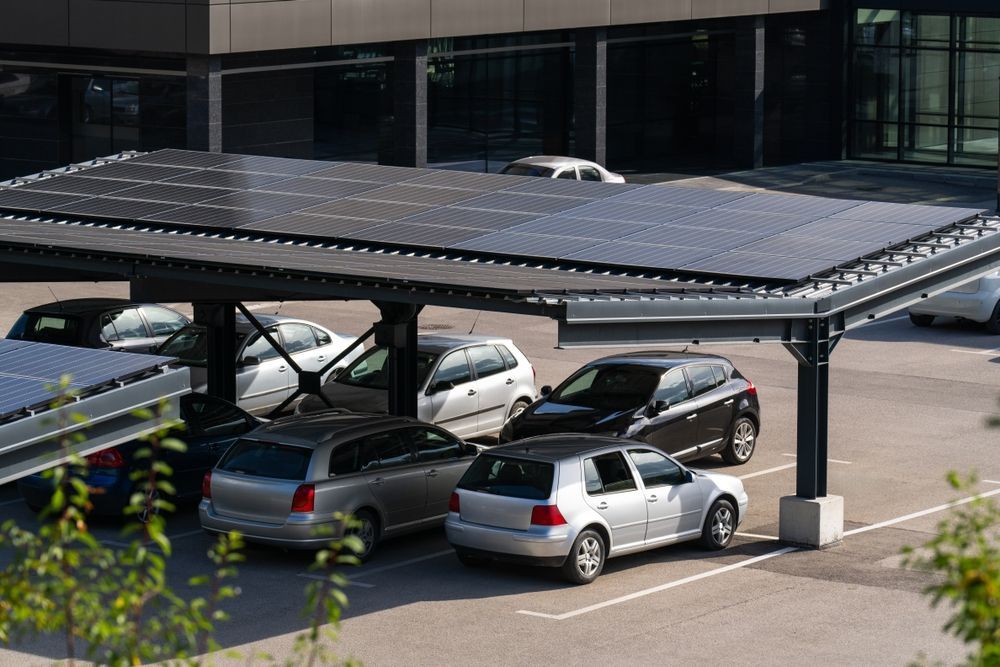 Cars Parked Under a Solar Panel Carport in A Parking Lot — Complete Sheds In Campbelltown, NSW