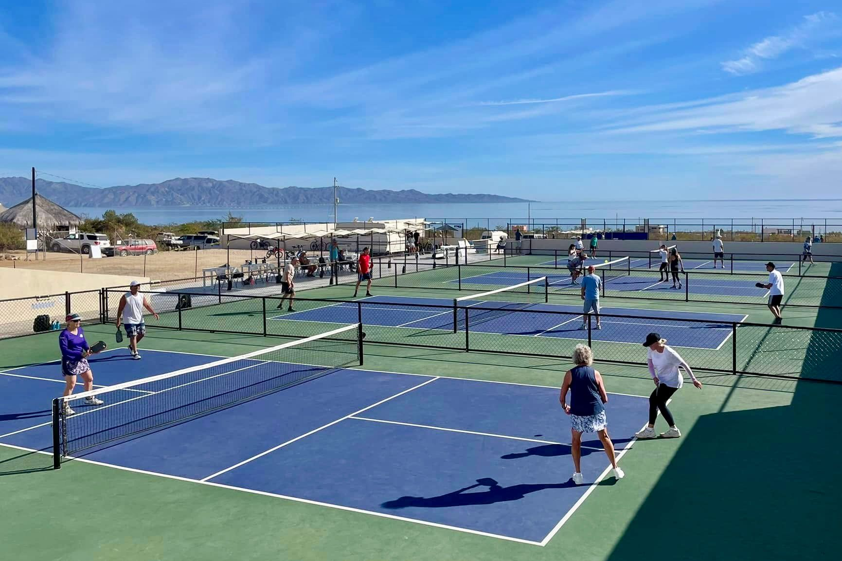 Person receiving back massage in a spa setting with candles and flowers.