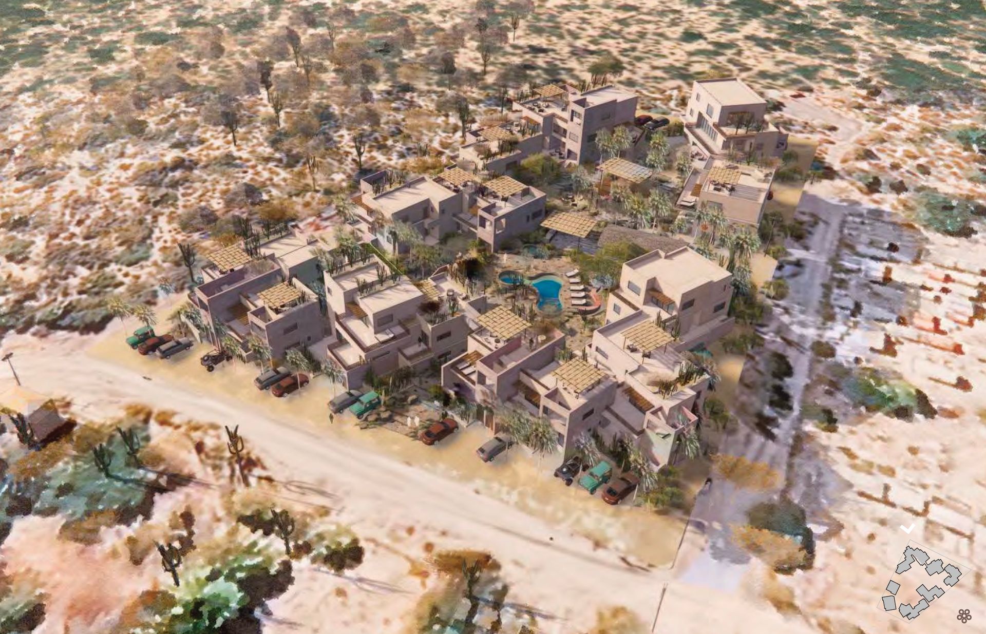 Aerial view of a town with square, flat-roofed buildings in a desert-like environment.