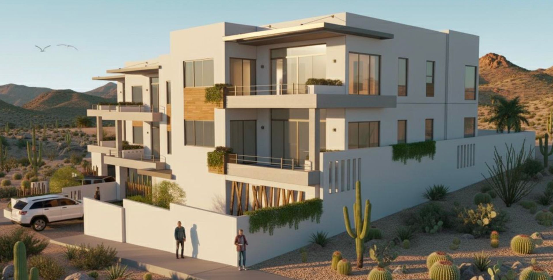 Modern multi-story building in a desert landscape; two figures stand near a white wall; a car parked nearby.