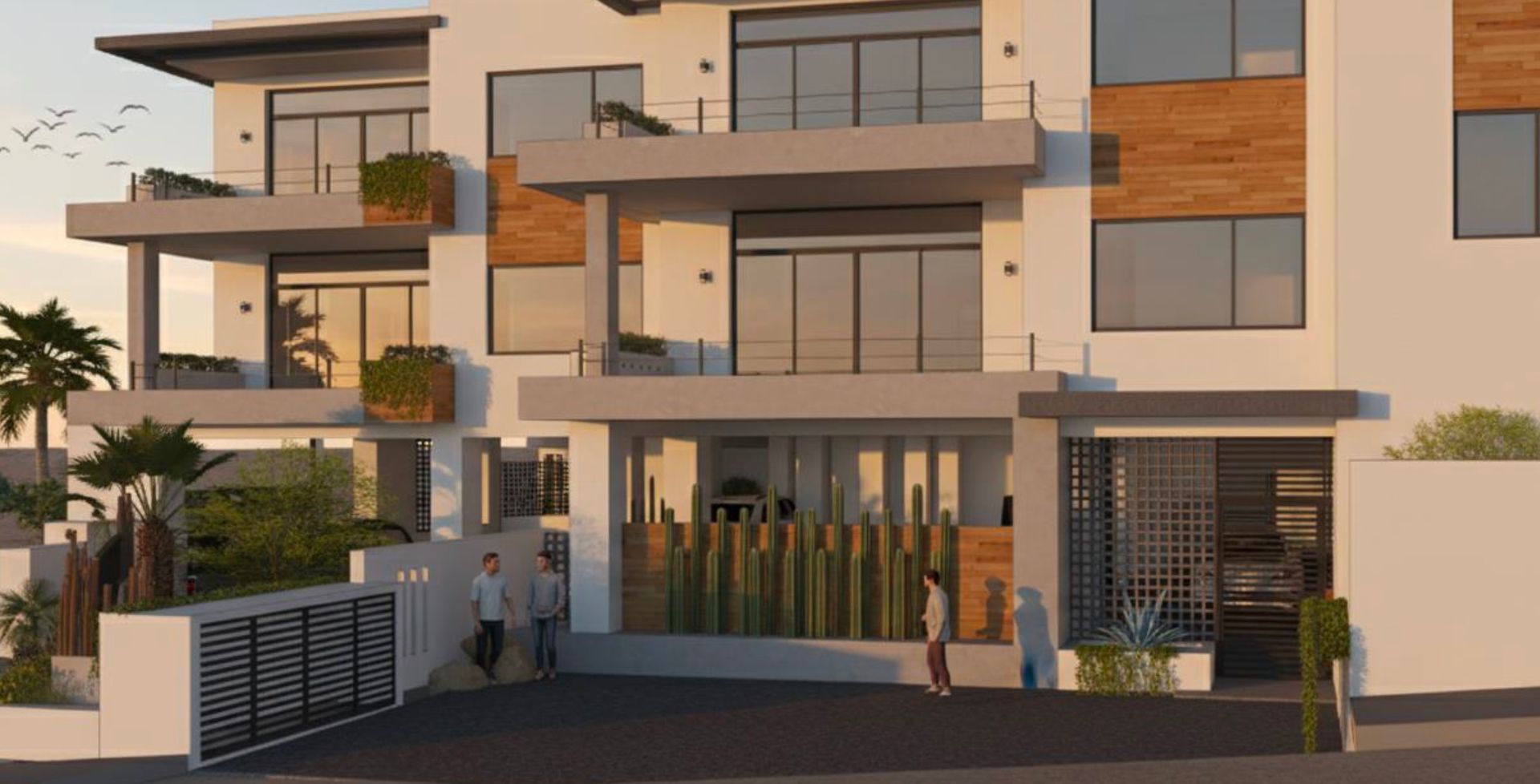 Modern white apartment building with balconies, wooden accents, and landscaping. People walk near entrance.