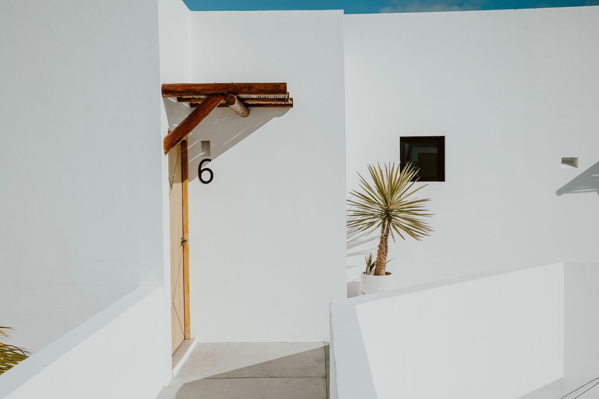 White building with wooden door labeled