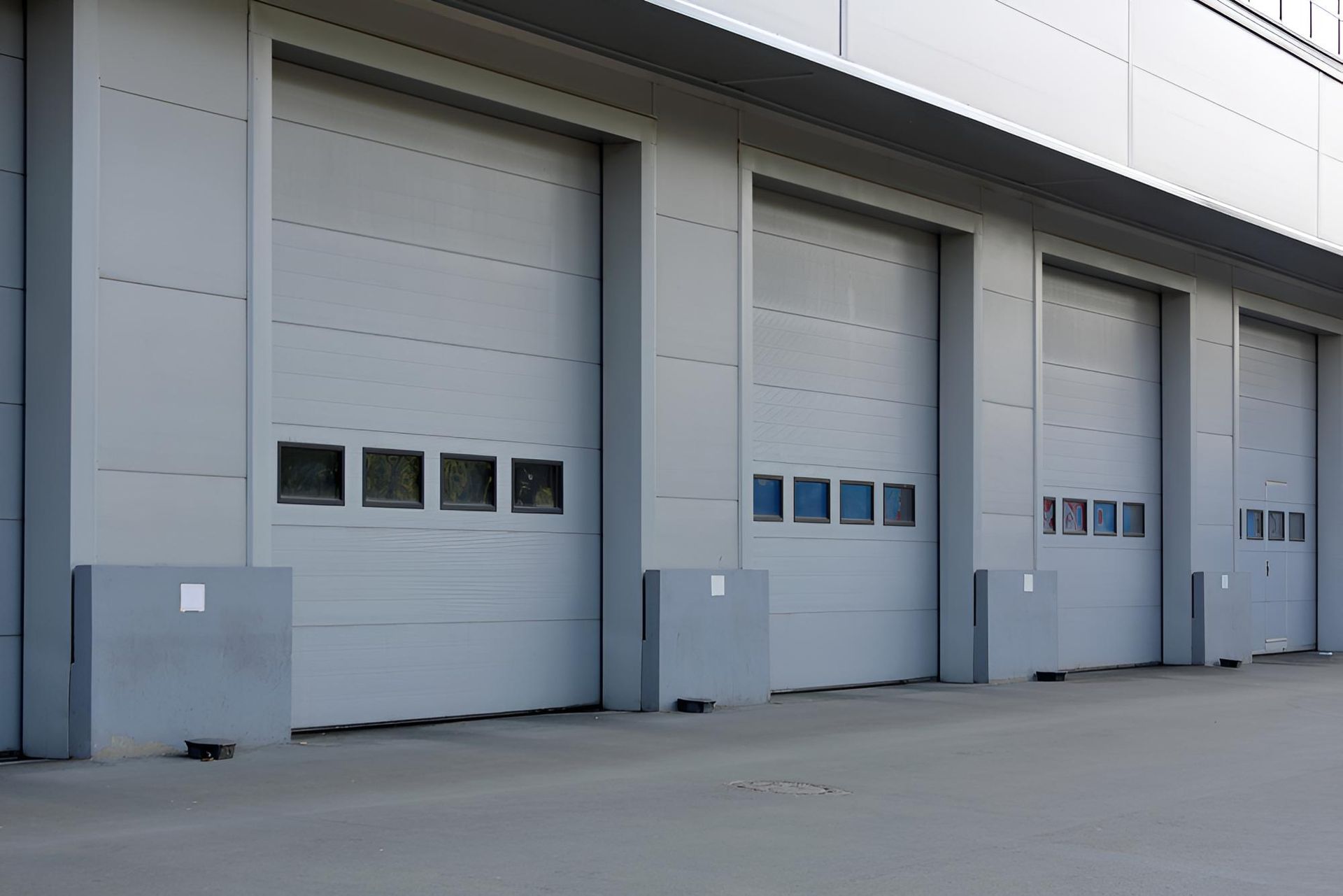 A Row of Garage Doors on The Side of A Building — Gold Coast Door Centre In Burleigh Heads, QLD