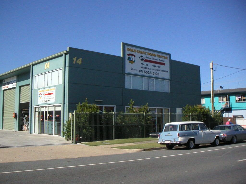A Green Building With The Number 14 On It — Gold Coast Door Centre In Burleigh Heads, QLD