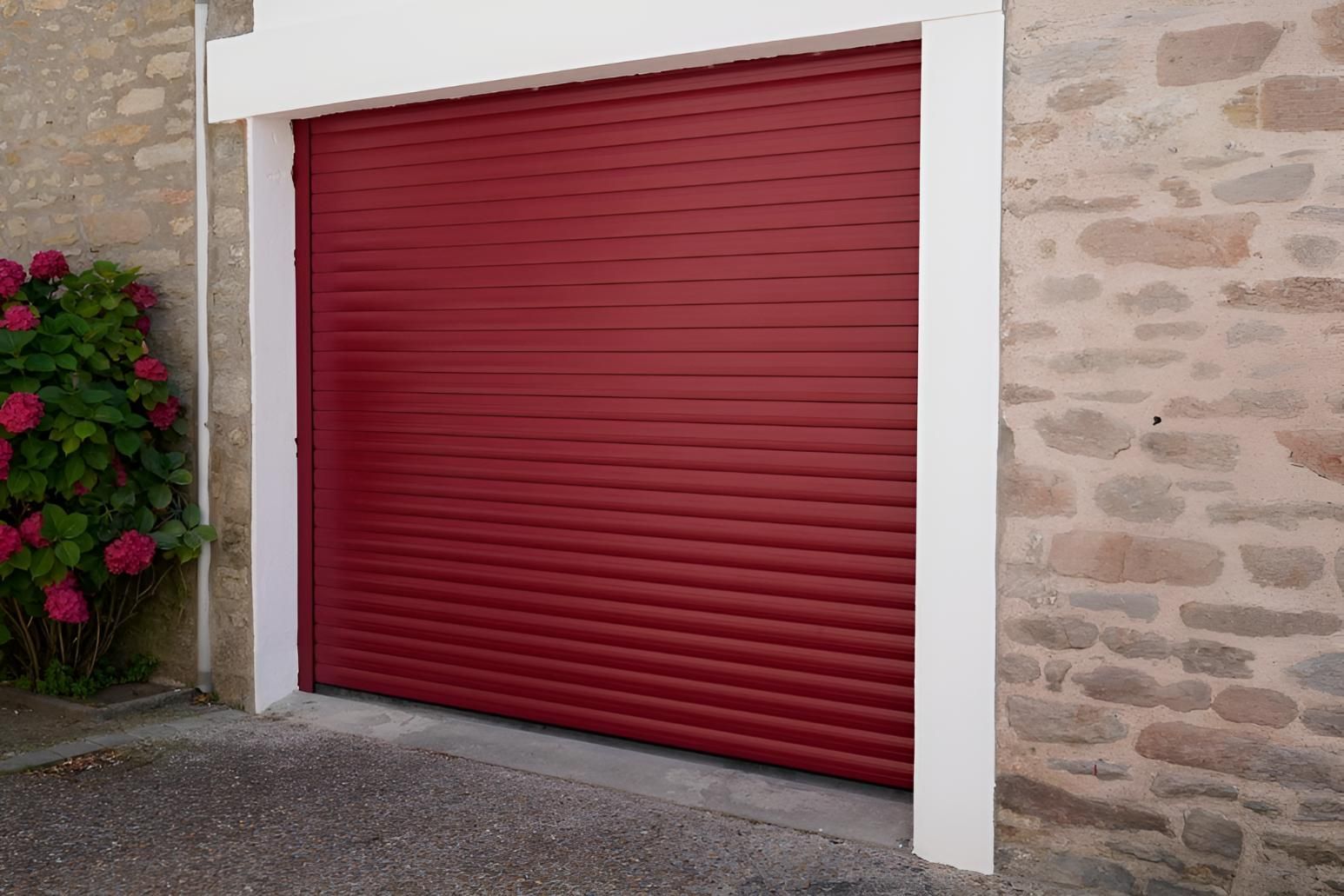 A Red Garage Door Is Sitting Next To A Stone Wall — Gold Coast Door Centre In Burleigh Heads, QLD