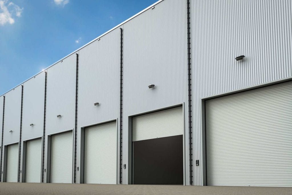 A Warehouse with A Lot of Garage Doors — Gold Coast Door Centre In Burleigh Heads, QLD