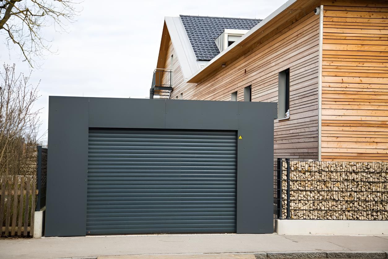 A Garage Door Is Sitting In Front Of A Wooden House — Gold Coast Door Centre In Burleigh Heads, QLD
