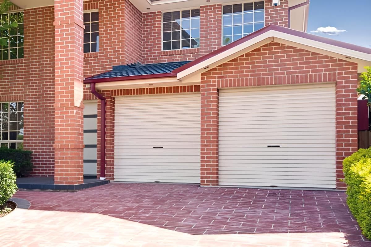 A Large Brick House With Two Garage Doors And A Driveway — Gold Coast Door Centre In Burleigh Heads, QLD