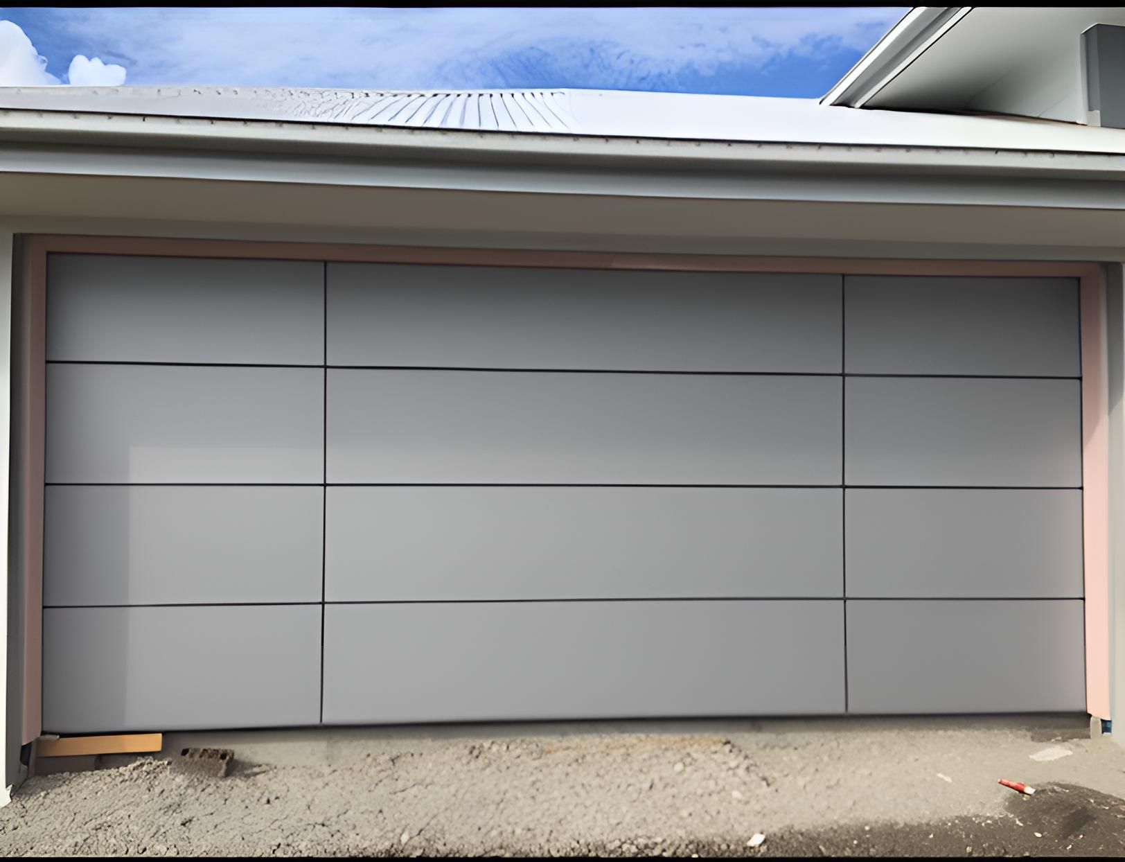 A Gray Garage Door Is Sitting In Front Of A House — Gold Coast Door Centre In Burleigh Heads, QLD