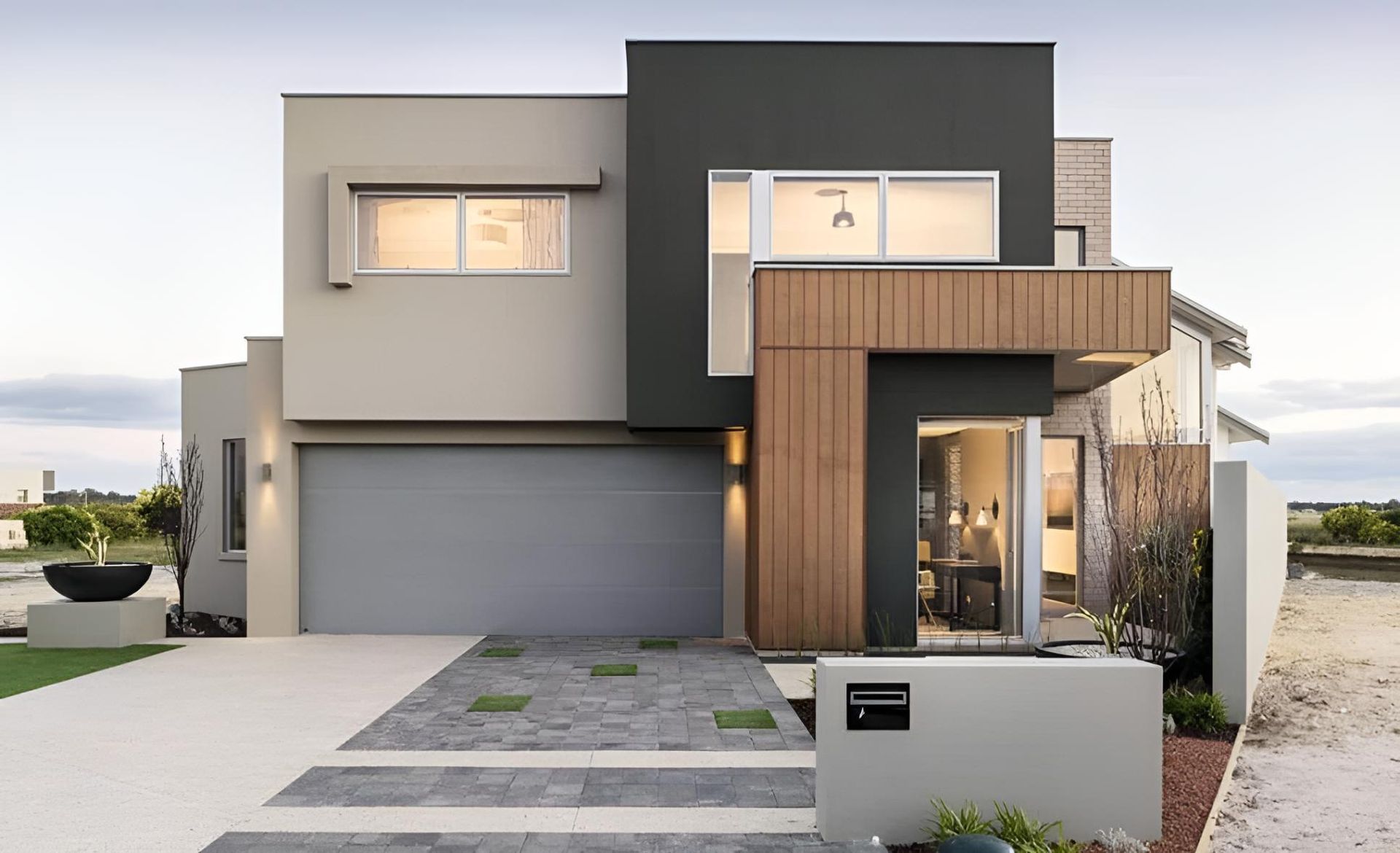 A Modern House With A Gray Garage Door And A Large Window — Gold Coast Door Centre In Burleigh Heads, QLD