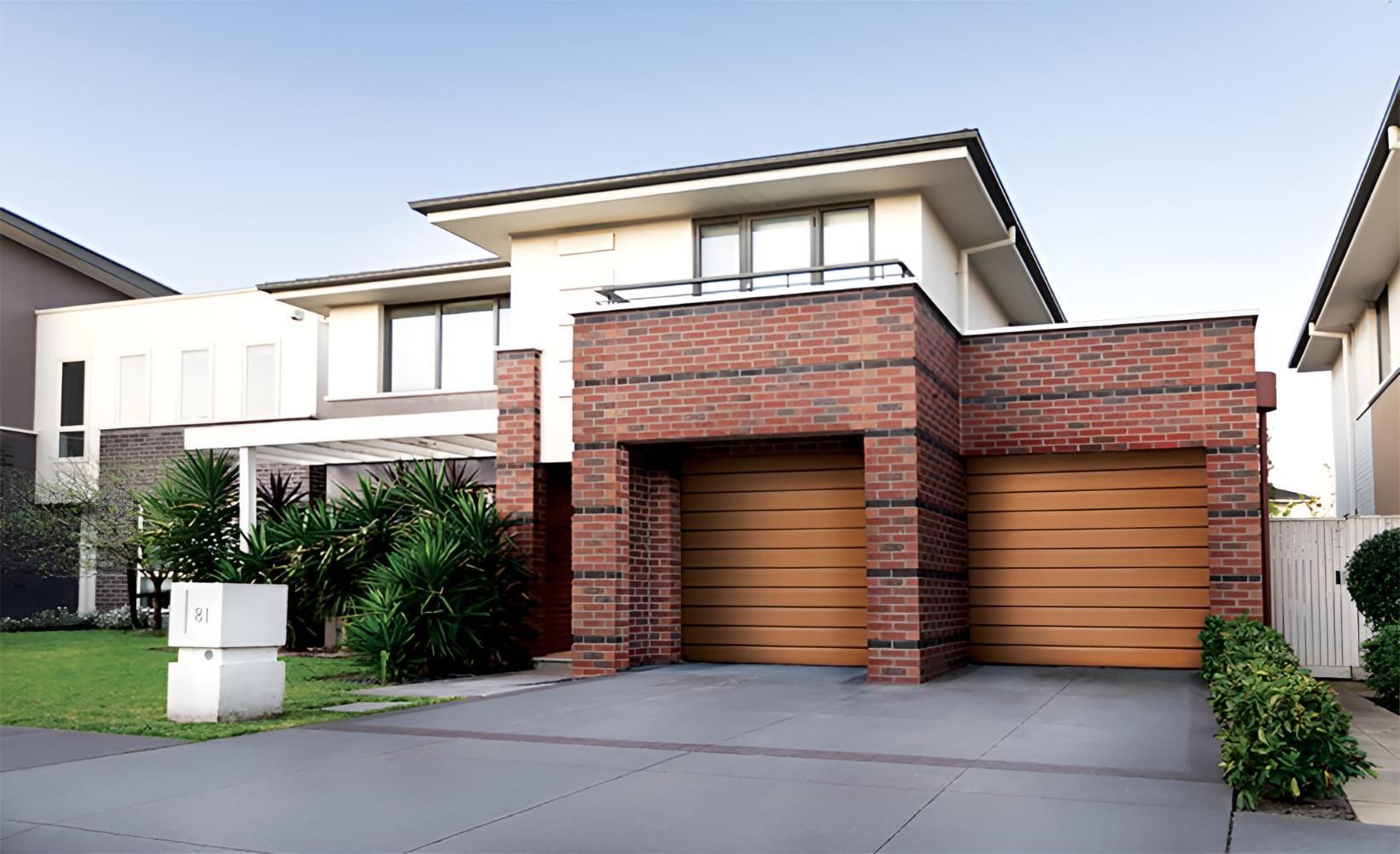 A Large Brick House with Two Garage Doors in A Residential Area — Gold Coast Door Centre In Burleigh Heads, QLD