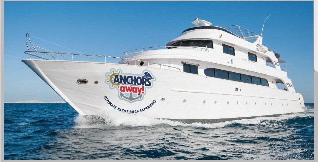 A large white yacht is floating on top of a body of water.