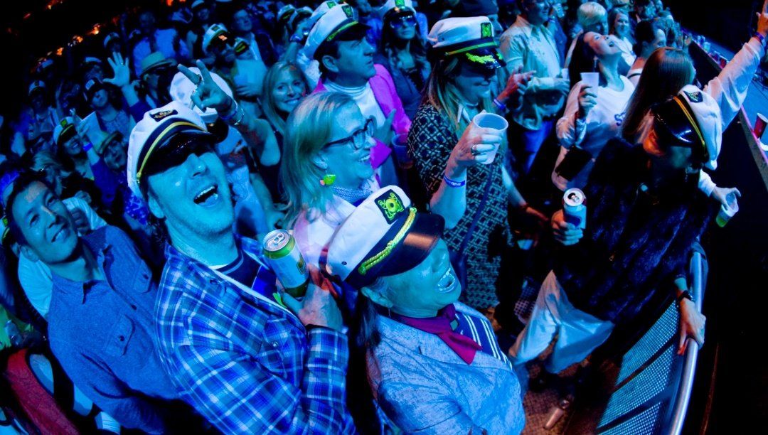 A group of people are standing in a crowd at a party.