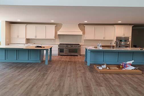 A kitchen with blue cabinets and white cabinets and a stove.