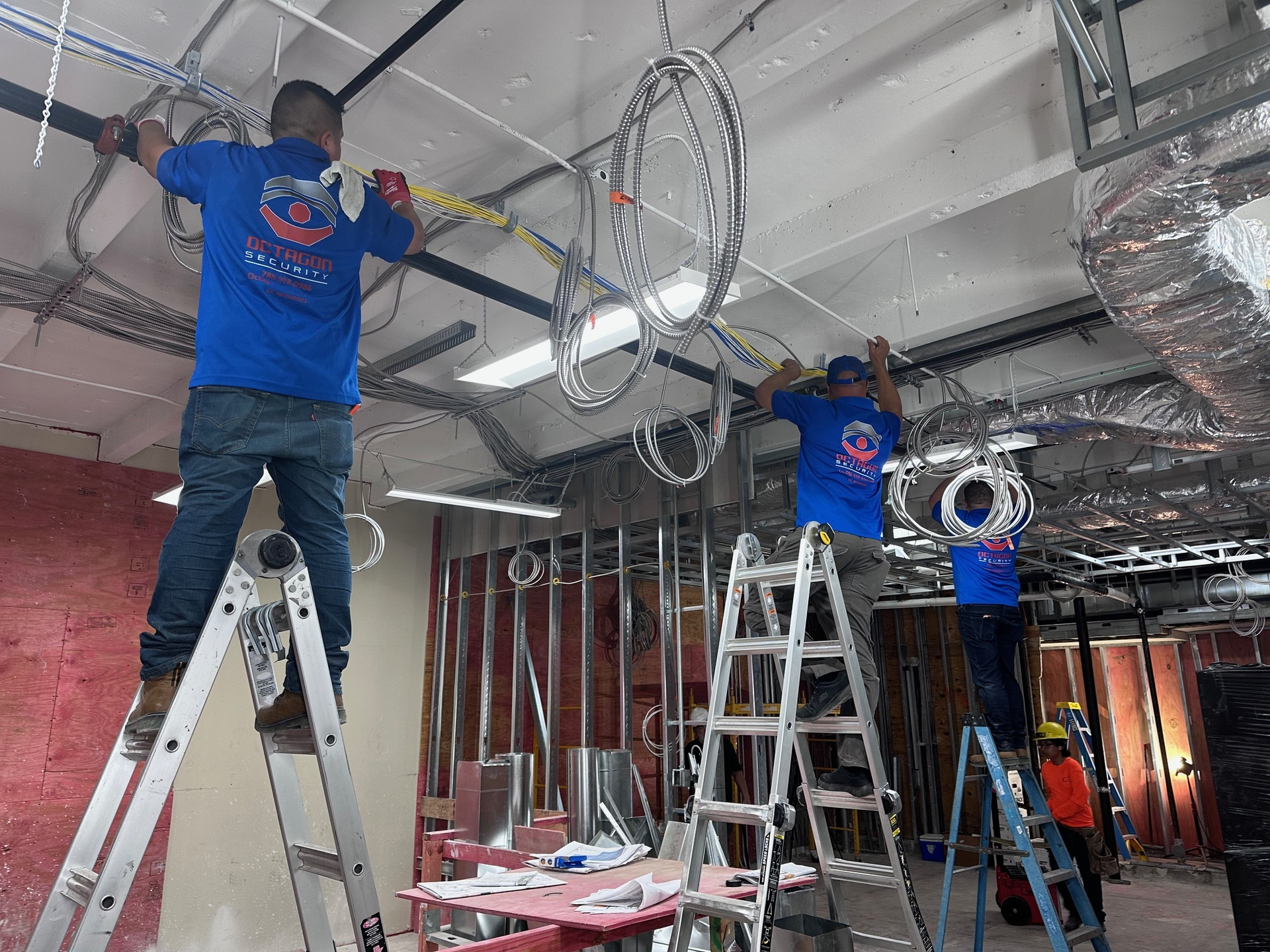 Black box with six toggle switches labeled 17-22, mounted on a gray concrete wall near a metal pipe.